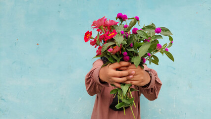 International Women's Day. young woman in brown dress holding zinnia flower 01