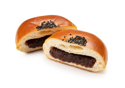 Anpan, cut in half, placed on a white background.