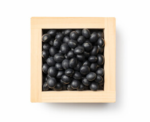 Black soybeans in a masu placed against a white background. Black soybeans (kurodazu).