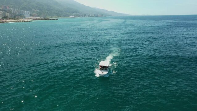 Aerial view of traditional fishing boat in Caraballeda with crystal clear turquoise sea, La Guaira, Venezuela.