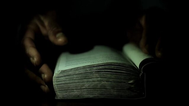 praying to God with hand on bible black background with people stock footage