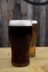 Brew. Closeup view of two beers, an amber ale and an ipa.