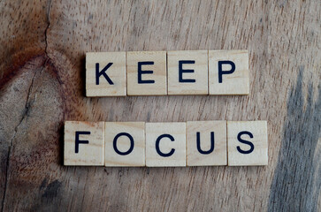 Keep focus text on wooden square, inspiration and motivation quotes