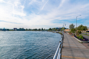 Fototapeta premium A boardwalk runs along the shore of St. Mary's River in the downtown area of Sault Ste. Marie, Ontario.