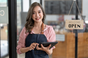 Startup successful small business owner sme beauty girl stand with tablet in coffee shop restaurant.