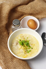 Asian congee with minced pork in white bowl.