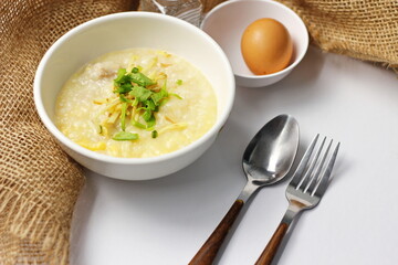 Asian congee with minced pork in white bowl.