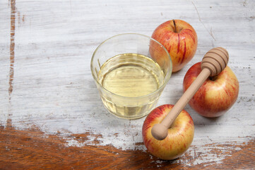 honey and apples on top of a rustic table