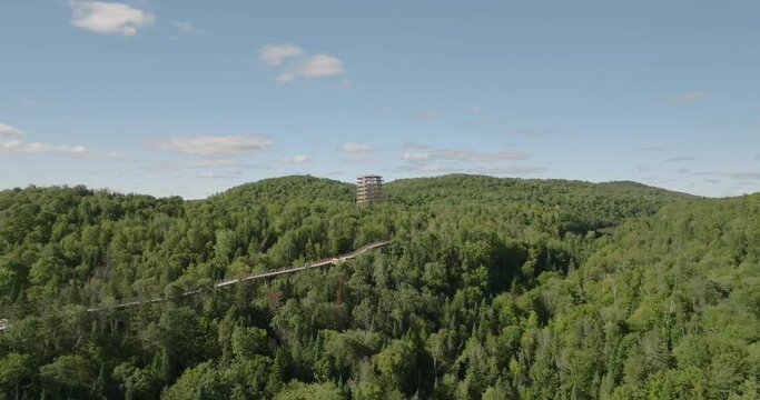 Beautiful wooden tower hiking trail. Mountains and trees. Wide landscape. Marvelous sunny summer day. 4k UHD drone push in, flying towards. Professional pilot.