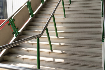 public staircase at station or mall for exit, entrance. stair inside the metro subway with cleanly steel handrail