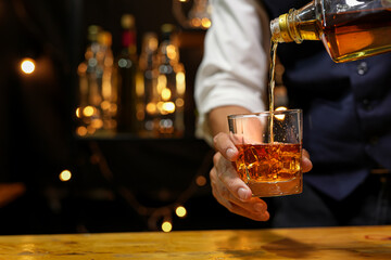 Bartender pouring Whiskey, on  bar,