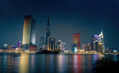 Fototapeta na wymiar view of Bitexco and IFC One Tower, buildings, roads and Saigon river in Ho Chi Minh city - Laser and lighting show displayed. Travel and landscape concept.