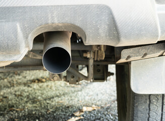 Car exhaust, gray car, the inside of the pipe is black soot caused by the combustion of the engine to help drain gas from the machine. parked cars.