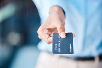 Credit card, shopping and macro hands of customer doing payment with a blur background. Money charge and transaction for commerce purchase with banking account in exchange for a product.