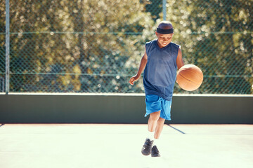 Fototapeta na wymiar Sports, athlete and child basketball player training for a match on an outdoor court in nature. Exercise, workout and healthy boy practicing his skill for a game on a professional field.