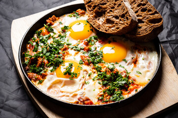 Shakshouka - spicy vegetarian breakfast with poached eggs