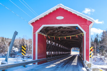 Ducharme red covered bridge in winter near La Tuque, QUebec (Canada)