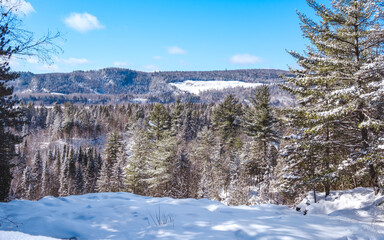 View on the Laurentien mountains covered with snow on a beautiful winter day in La Tuque, Quebec (Canada)