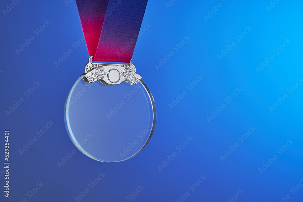 Sticker transparent silver crystal medal against blue background