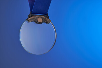 transparent bronze crystal medal against blue background
