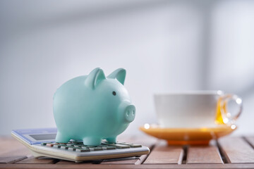 piggy bank with calculator and cup of coffee