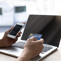 Businessman use mobile phones to register for security Online with a credit card to buy products online through application,Online shopping or Internet technology concept.