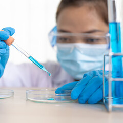 Scientists are carrying blue chemical test tubes to prepare for the determination of chemical composition and biological mass in a scientific laboratory, Scientists and research in the lab Concept.