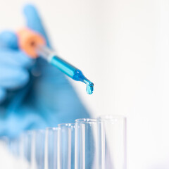 Scientists are carrying blue chemical test tubes to prepare for the determination of chemical composition and biological mass in a scientific laboratory, Scientists and research in the lab Concept.
