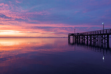 Fototapeta na wymiar Pier on Mobile Bay at sunset in Daphne, Alabama