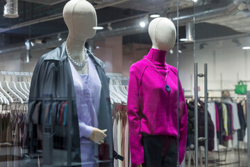 Mannequins in the window of a women's clothing store. Fashion & Style. Advertising of the new...
