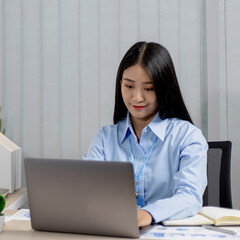 Asian woman is studying online via the internet with a cheerful smile, stay home, New normal, Covid-19 coronavirus, Social distancing, Internet learning.