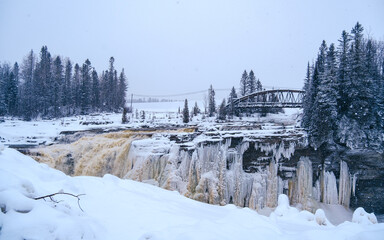 View on the frozen waterfall of Chute-Aux-Galets on a snowy winter day near Saguenay, Quebec (Canada)
