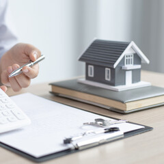 Real estate agent or sales manager has offered home sales and explained the terms of signing the house purchase contract and free home insurance, Finance and after-sales service concept.