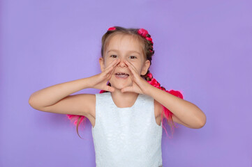 Sale, discount, win, winner's concept. An impressed, happy, cute girl with pink hair looks into the camera with her mouth open and screams against purple background. Advertising of a children's store