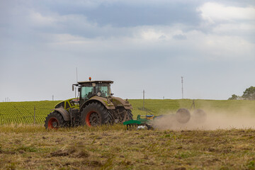  tractor plows the ground