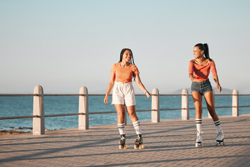 Friends roller skating on the promenade at the beach during a summer vacation in South Africa....