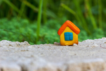 Small house figurine from colored clay. Real estate concept