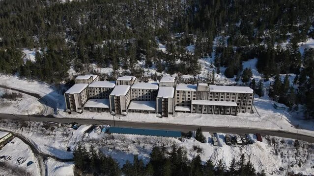 Aerial view of the abandoned Buckner building in Whitter Alaska during the winter with snow on the rooftop, world war 2 building 