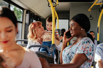 Black woman talking on smartphone in bus