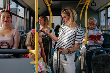 Mom and daughter riding airport shuttle to travel