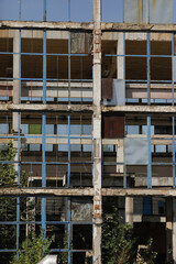 Fototapeta na wymiar Broken walls and windows in an abandoned industrial building.