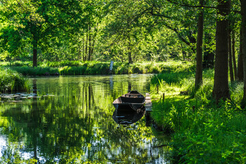Water canal in the Spreewald Biosphere Reserve in Germany, with one of the typical wooden boats.