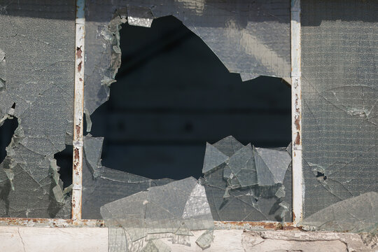 Broken walls and windows in an abandoned industrial building.