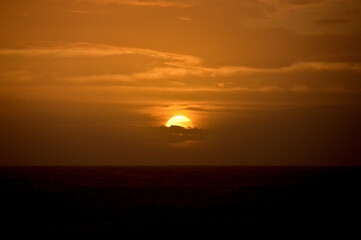 Fototapeta na wymiar Brilliant Orange Sunset over the Ocean