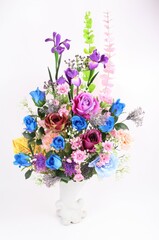 Multicolored arrangement of flowers in vase isolated on a white background