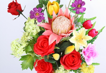 Multicolored arrangement of flowers in vase isolated on a white background