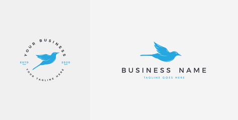 Modern bird logo in flight in bright blue color.