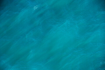 Sea water texture. Sunlight ray in surface of water. Abstract art background. Scenic natural design in water waves. Wallpaper for desktop.