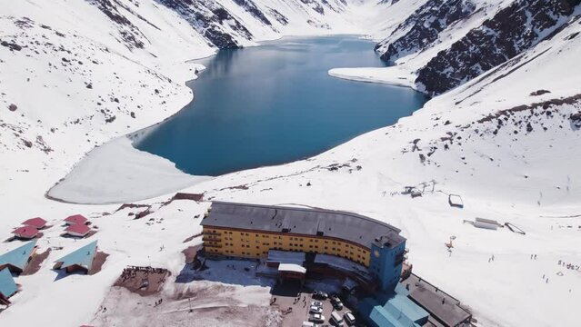Fly Over Portillo Ski Resort And Hotel Accommodations Towards The Lake In Las Condes, Chile. Aerial Drone Shot