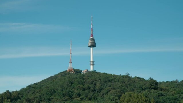 Zoom out from N Seoul Tower against blue clear sky in summer viewed from Haebangchon HBC district